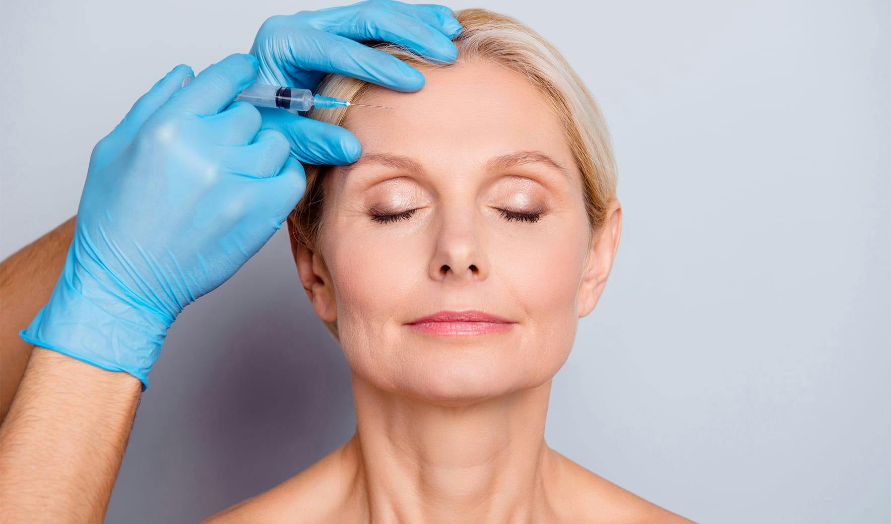 woman getting injection on her forehead