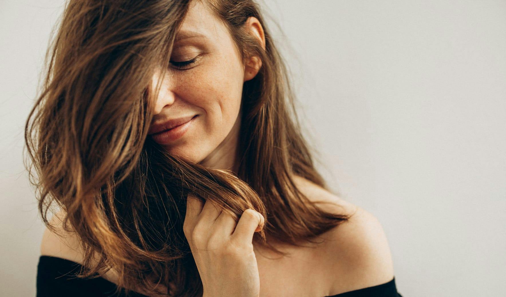 woman feeling her hair