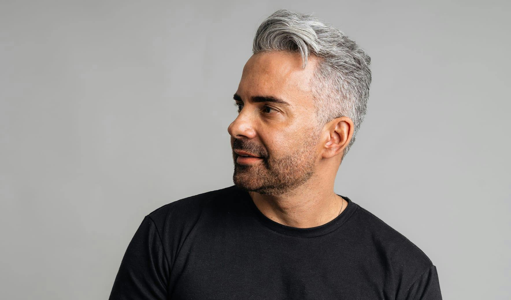 man with gray hair looking left