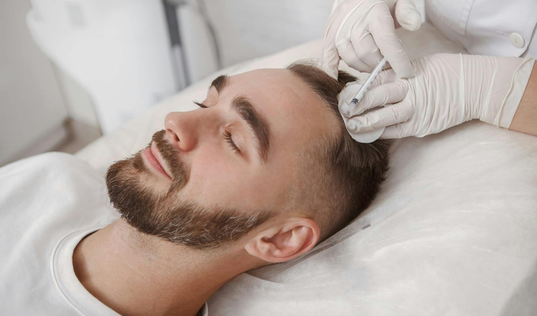 man getting an injection in his hairline