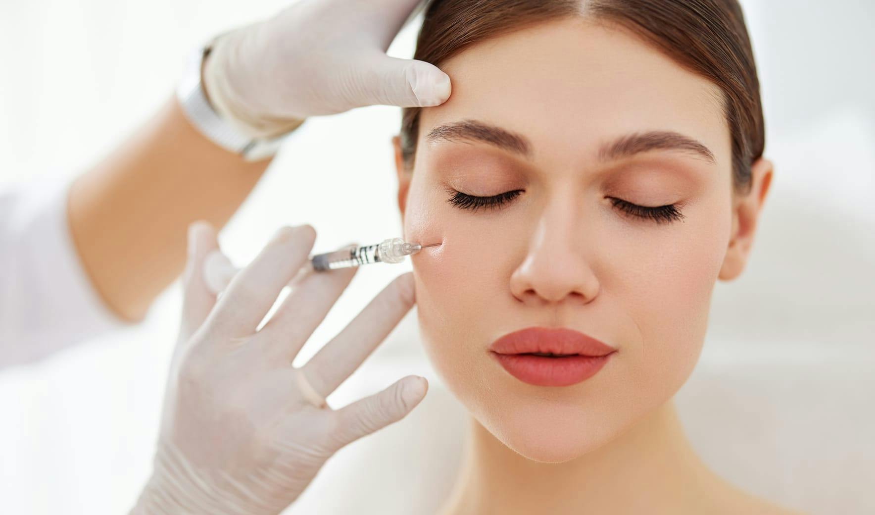 woman getting an injection in her cheek