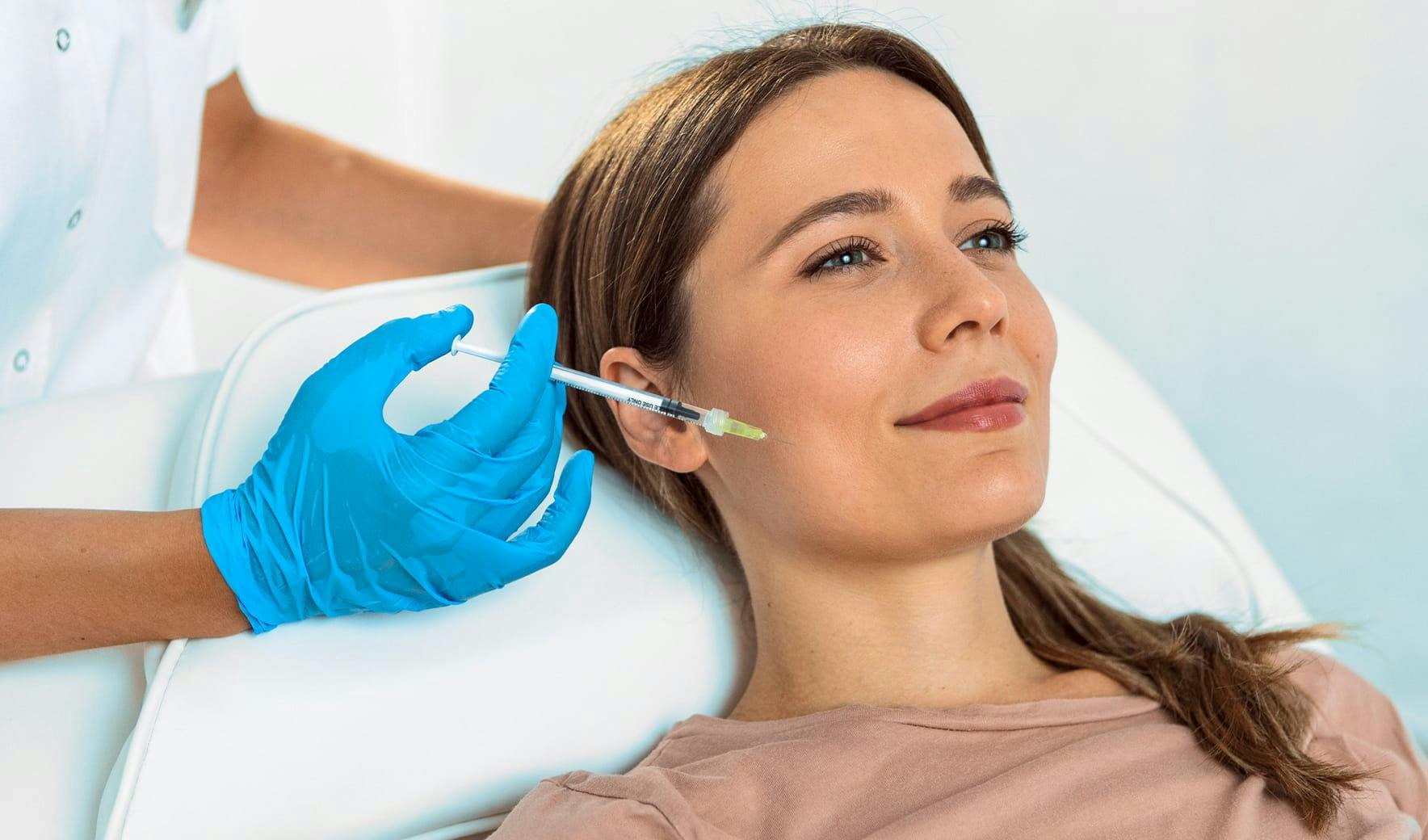 woman getting an injection in her cheek