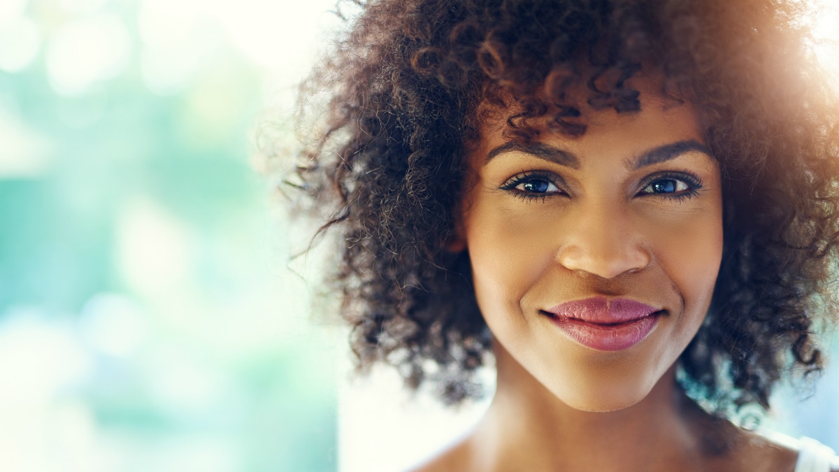 Smiling young woman in sunshine