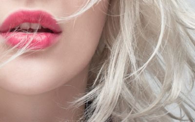 Woman with dark pink lipstick on