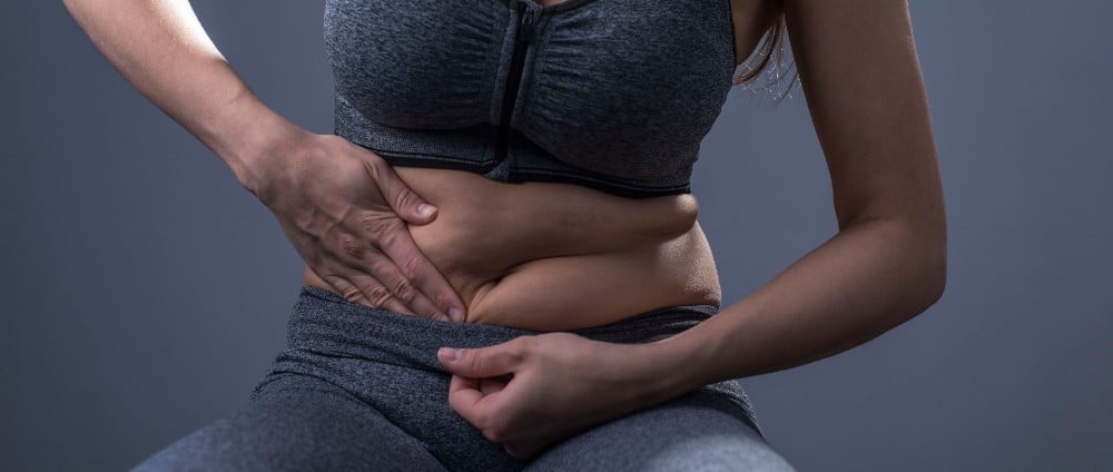 Woman touching her abdominal area