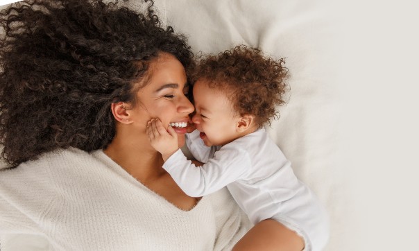 Mom with child smiling after mommy makeover