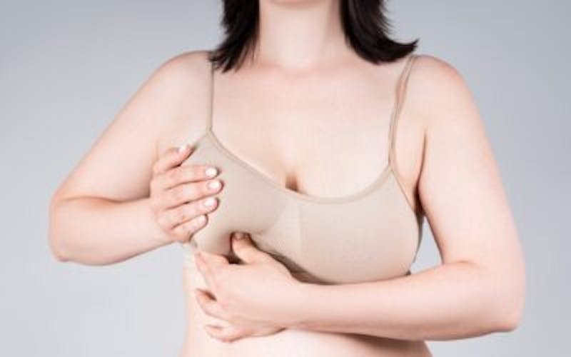 Woman examining her breast