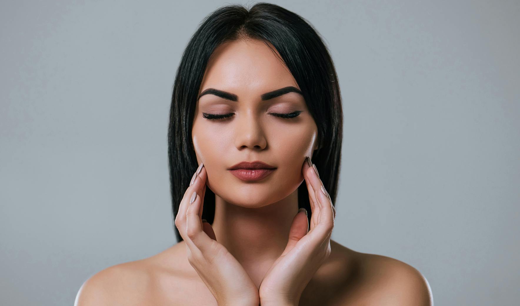 woman touching her face with her hands