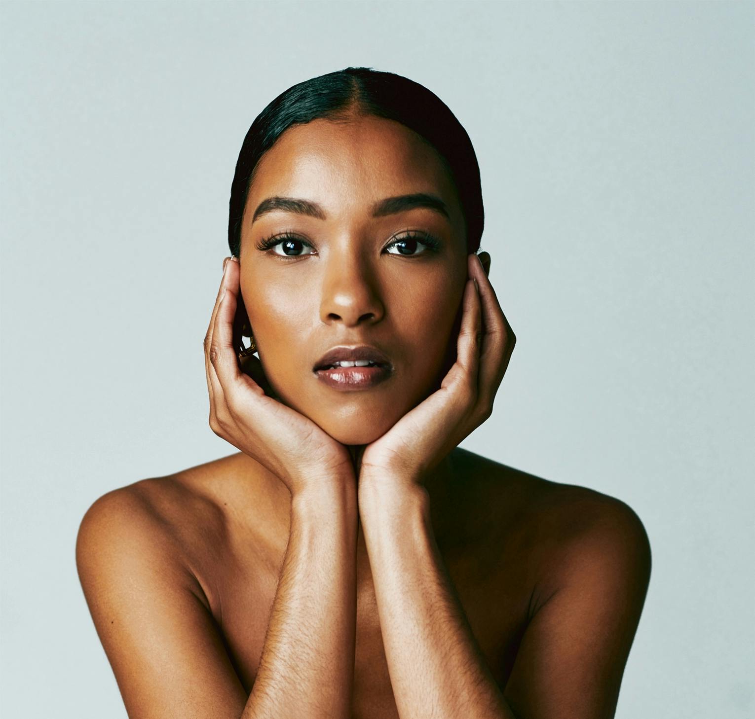 woman cupping her face in her hands