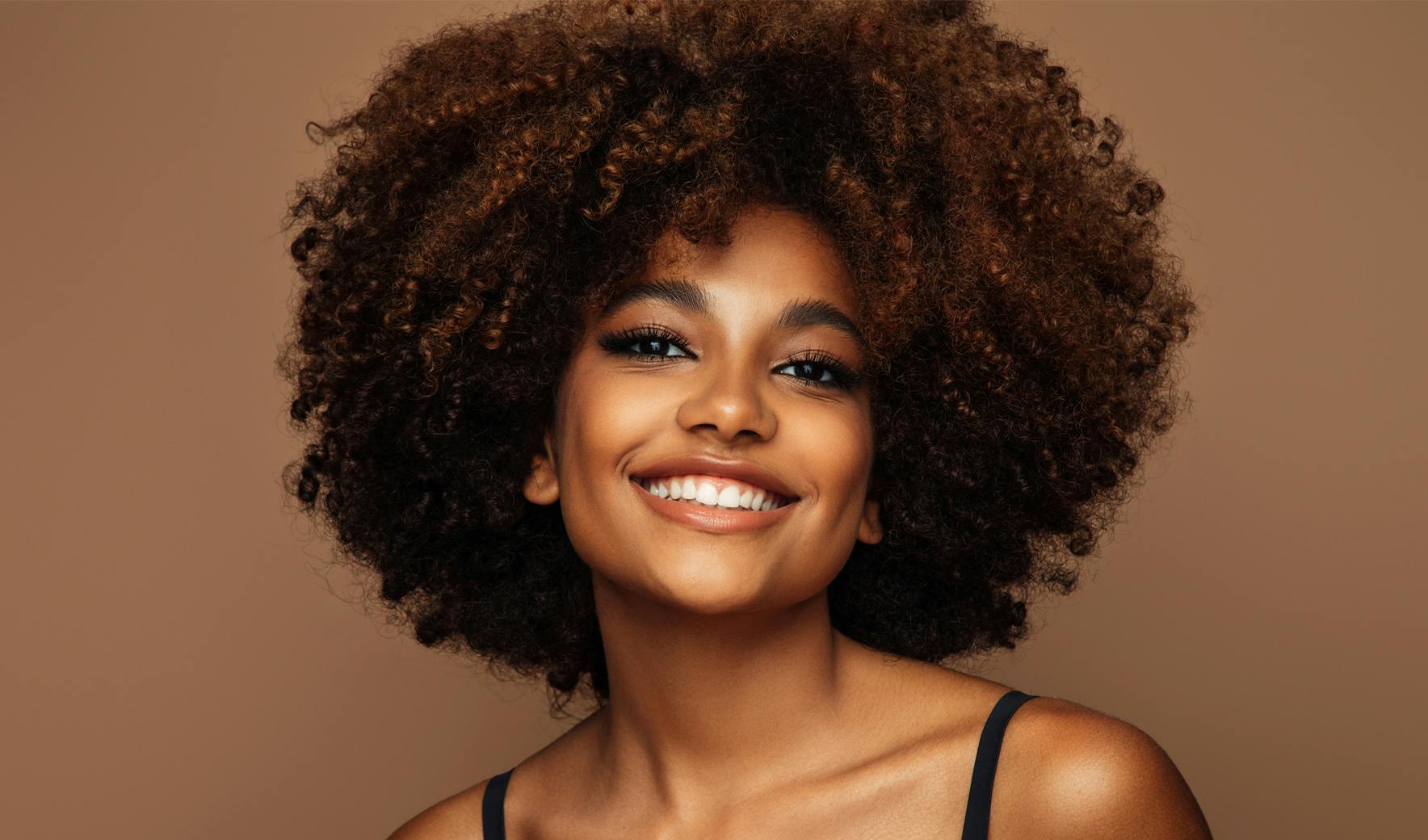 woman with afro hair smiling