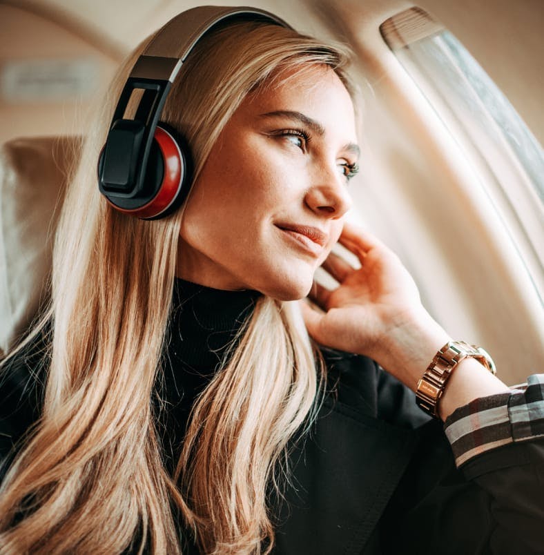 Woman on a plane wearing headphones