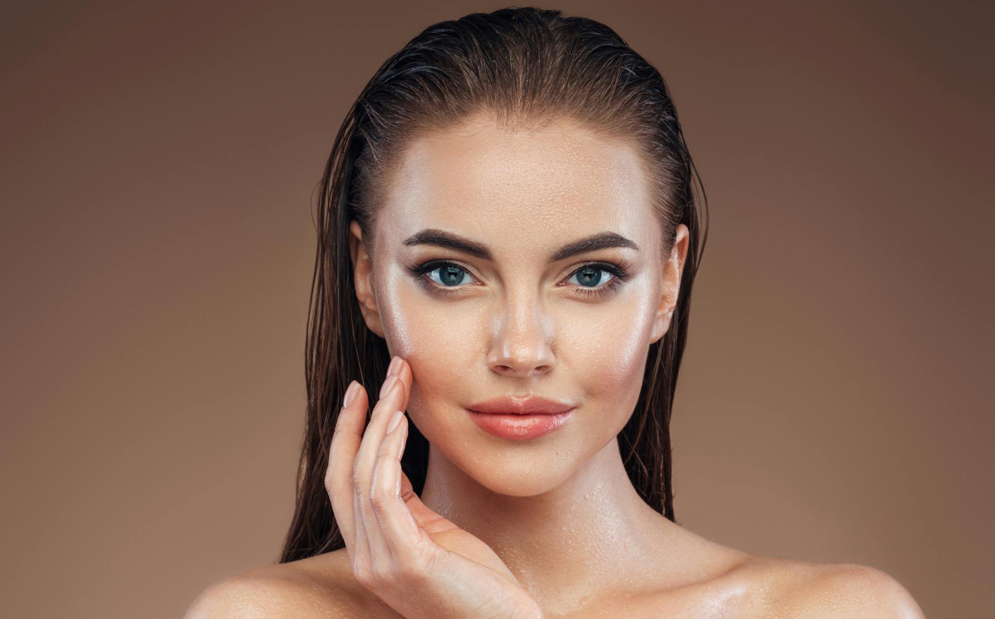 Beautiful woman smiling and touching her face