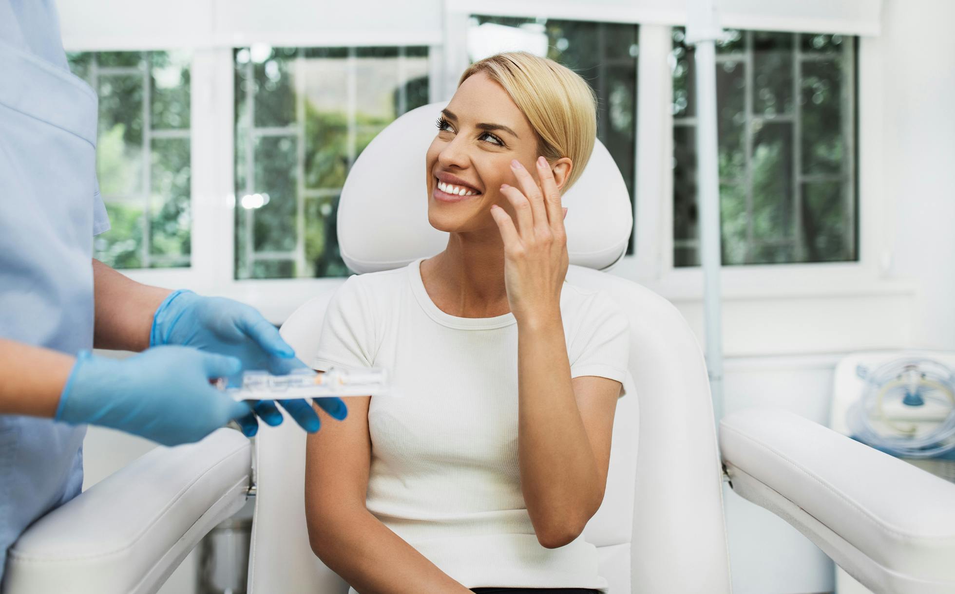 Woman smiling and speaking with doctor