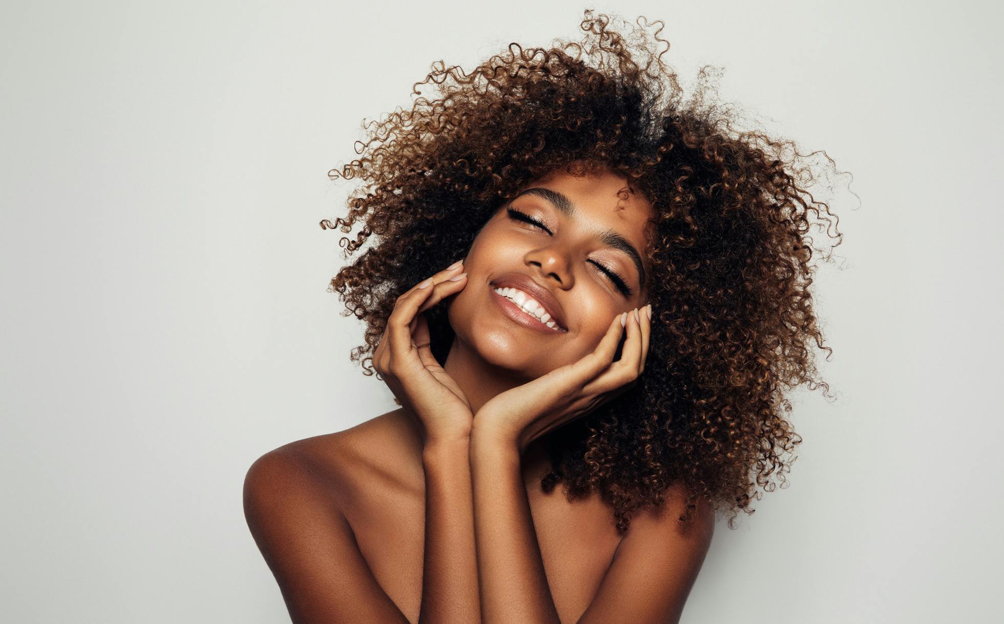 Beautiful woman smiling with eyes closed