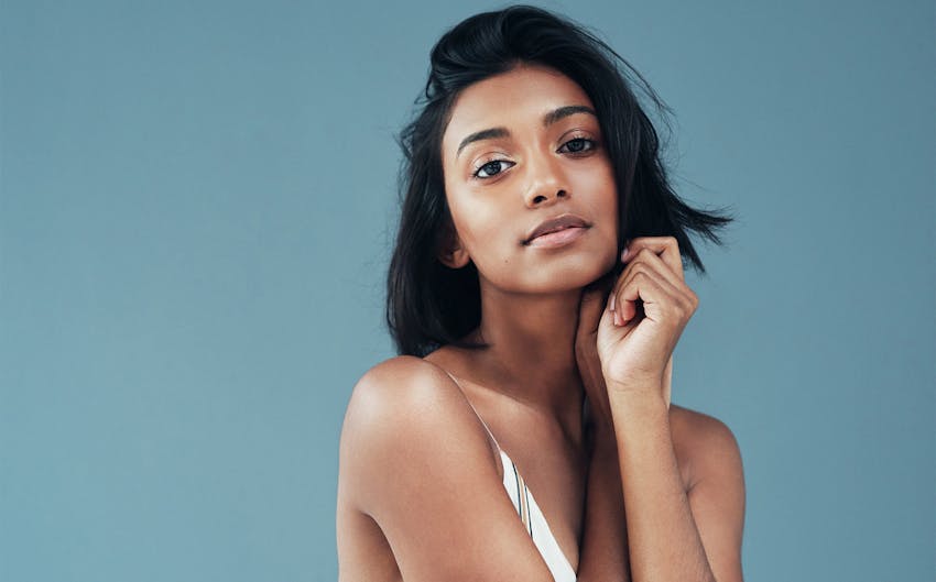 Woman holding hands to her face