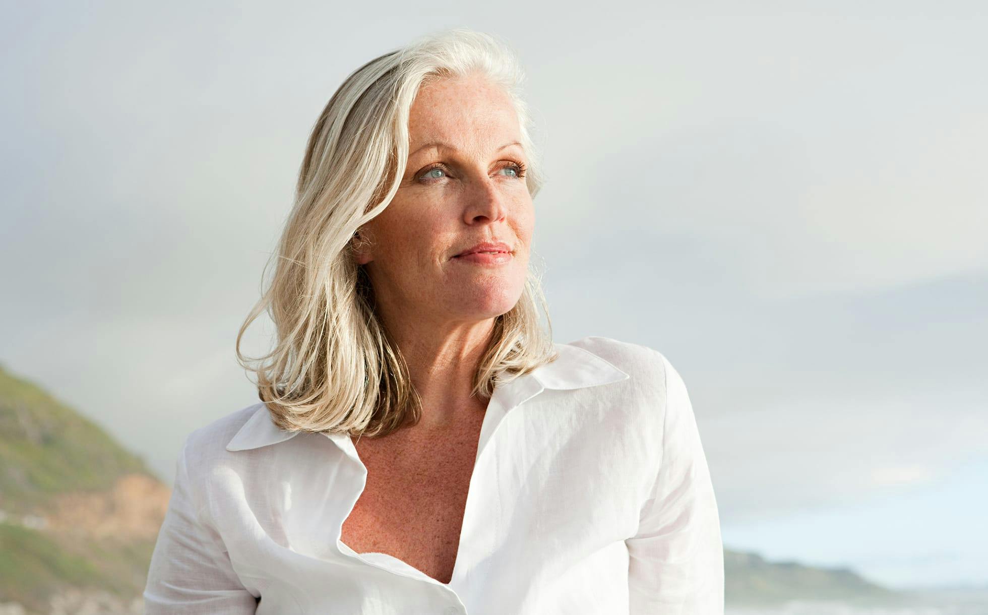 woman looking straight ahead with hands under chin
