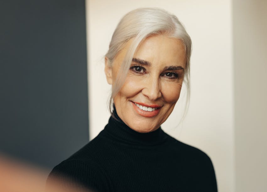 Beautiful older woman wearing a black turtleneck