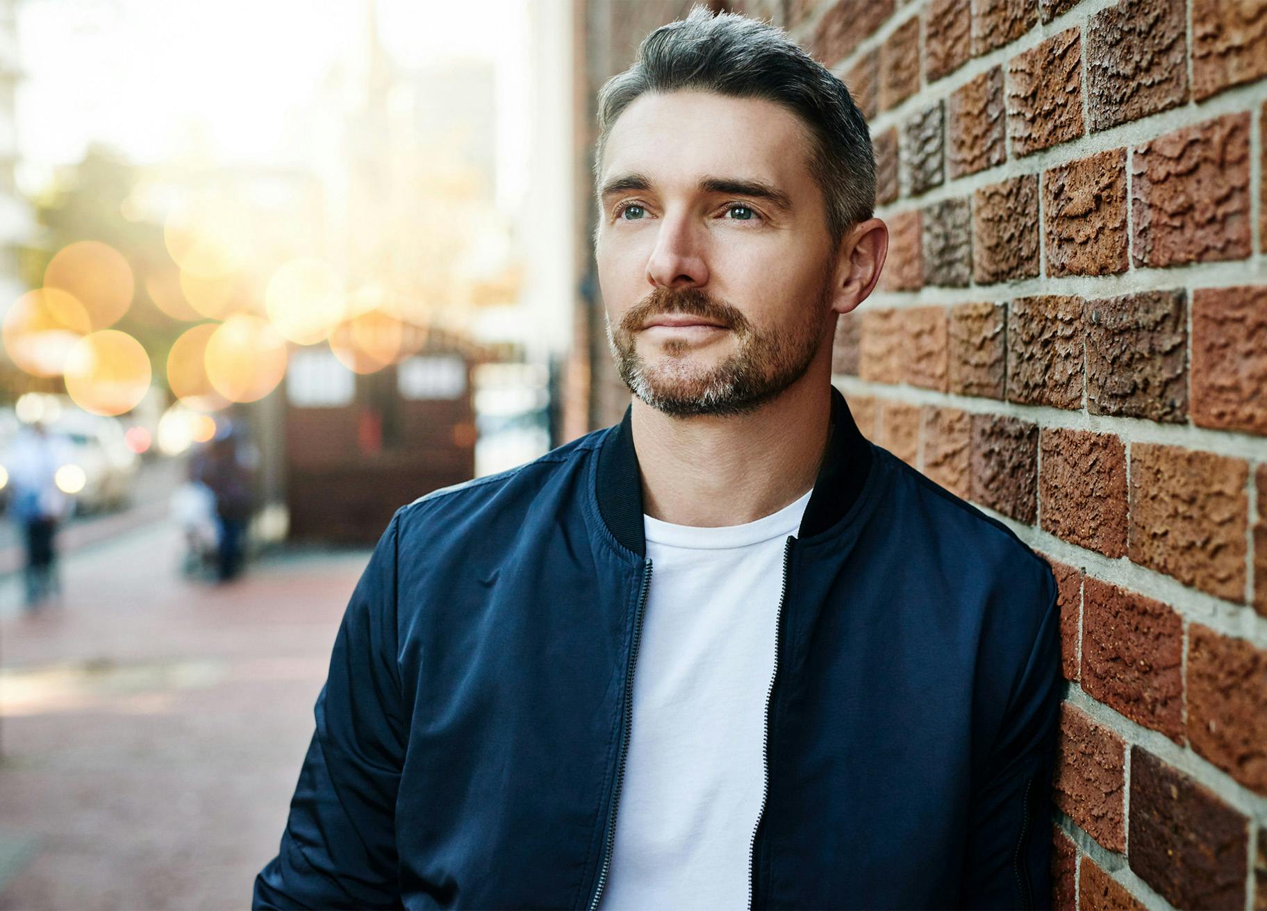 Man in a white shirt and blue jacket