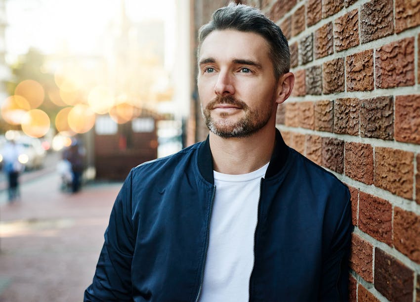Man in a white shirt and blue jacket