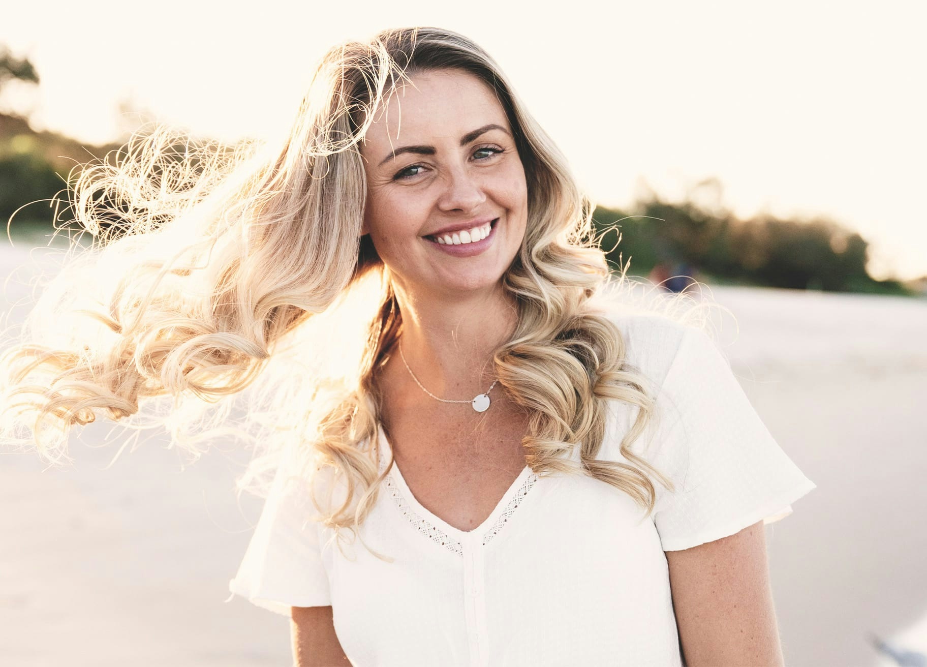 Woman on the beach, smiling