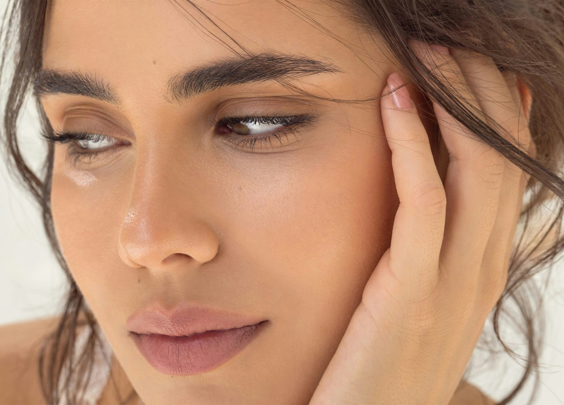 a woman with her hand on her face