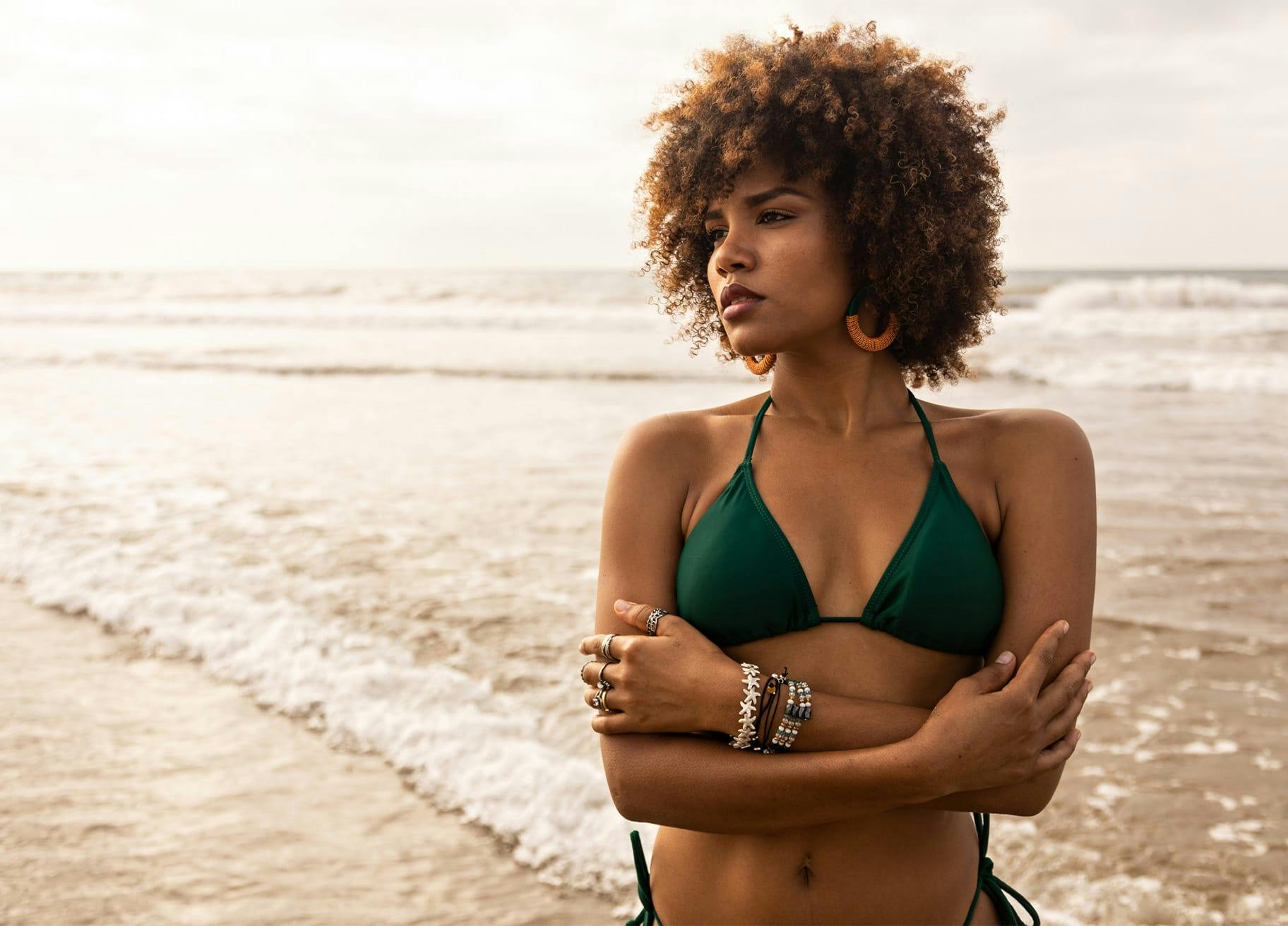 woman with curly hair at the beach