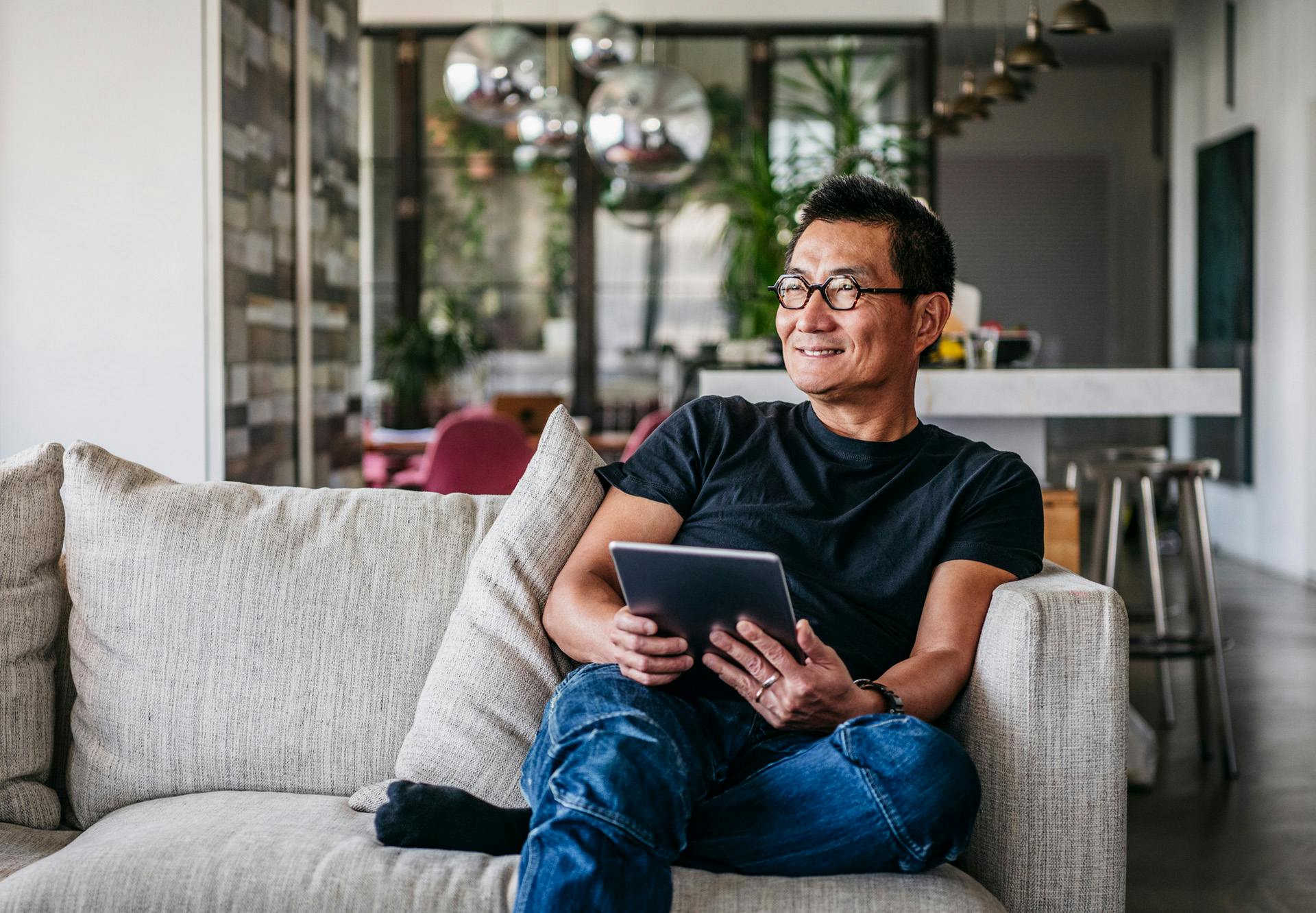 sitting on couch with tablet