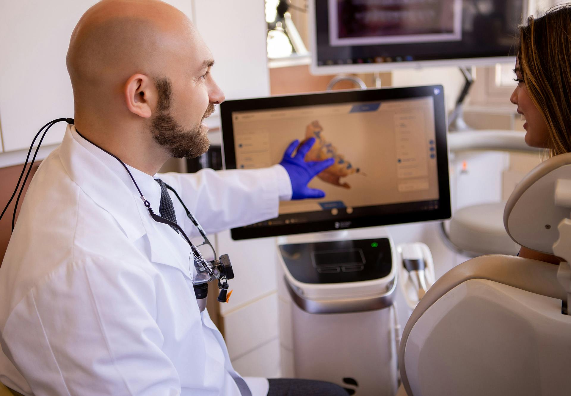 Dr. Samadian showing a patient information on a screen