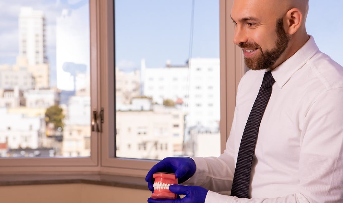 doctor explaining with teeth model