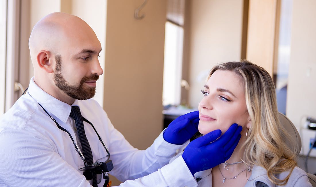 doctor checking jaw muscles