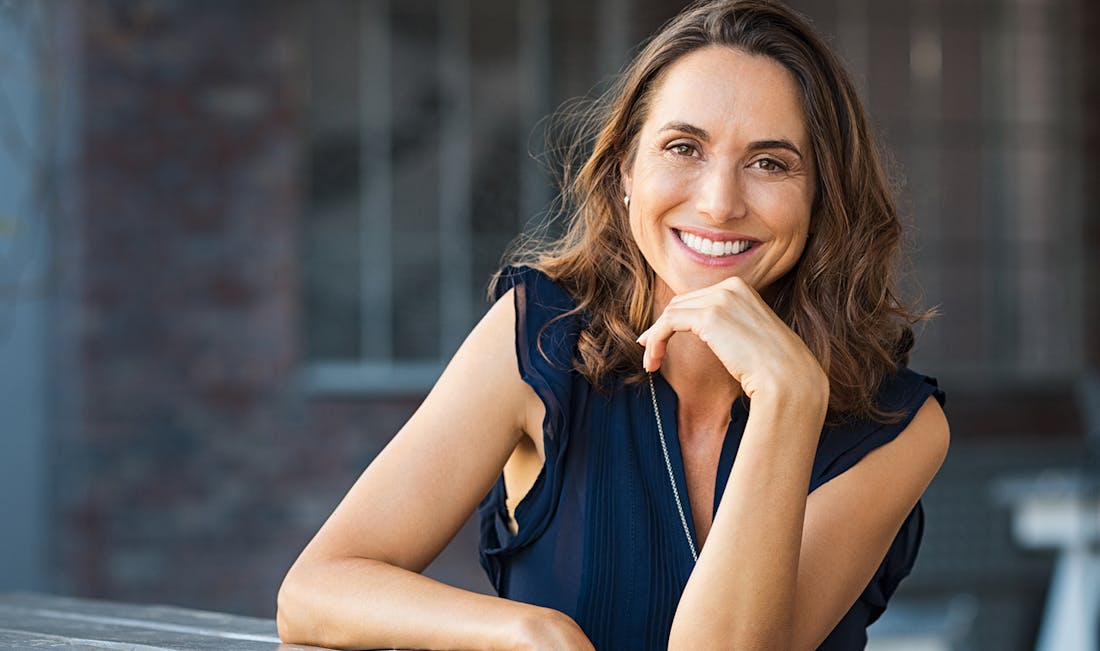 smiling in blue blouse