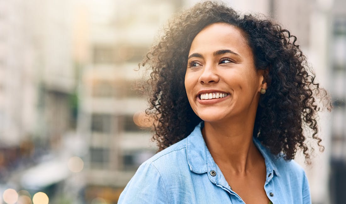 smiling with city in background