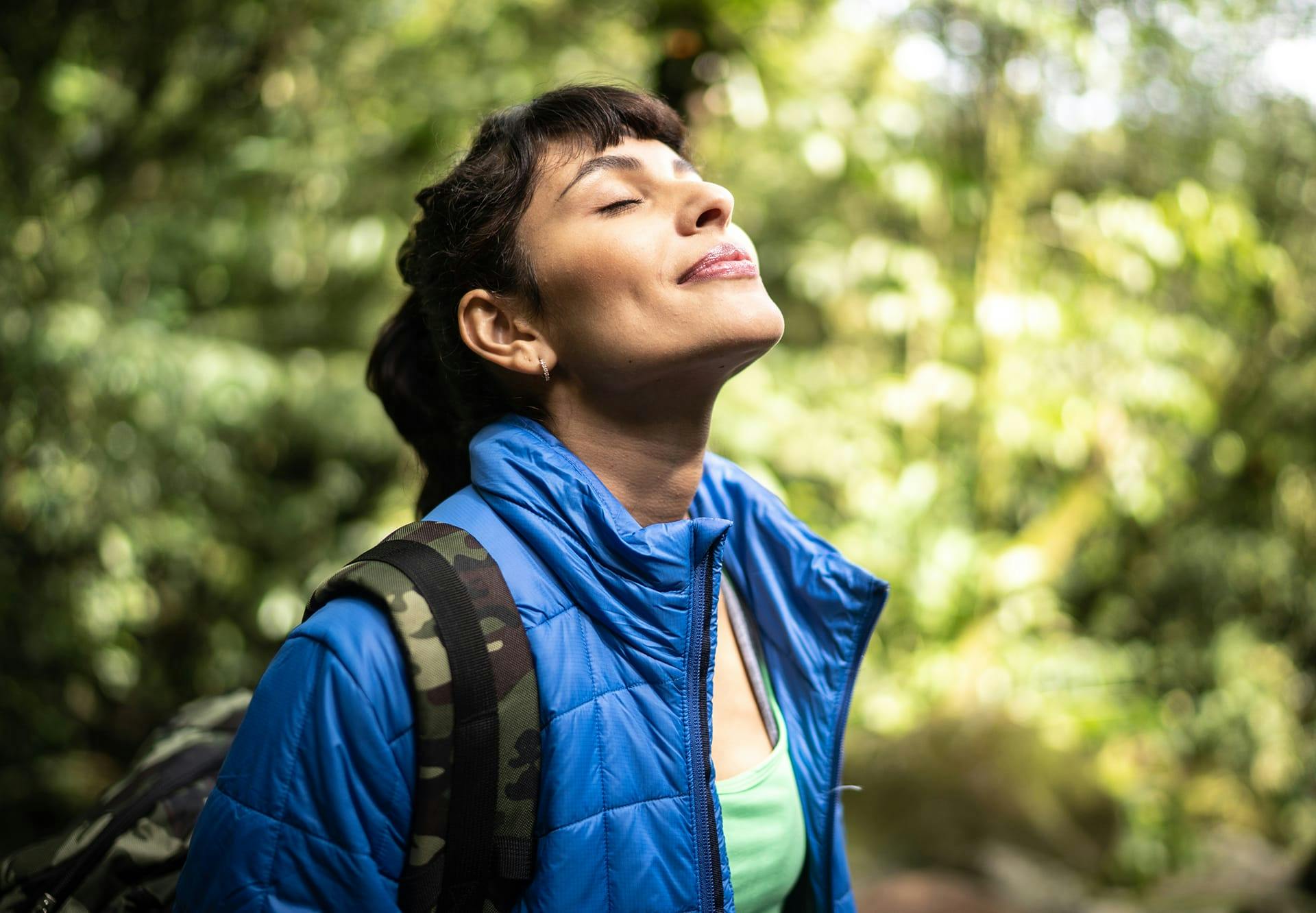 woman breathing fresh air in nature