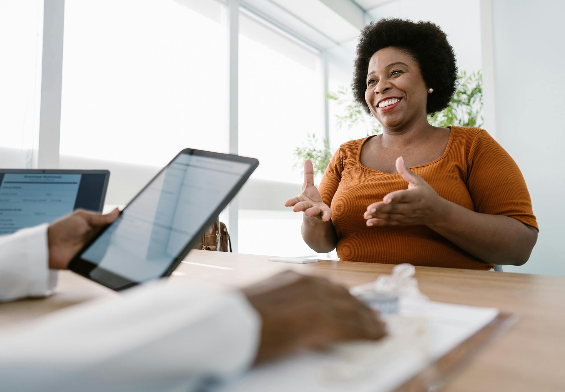 African American patient talking to her African American doctor