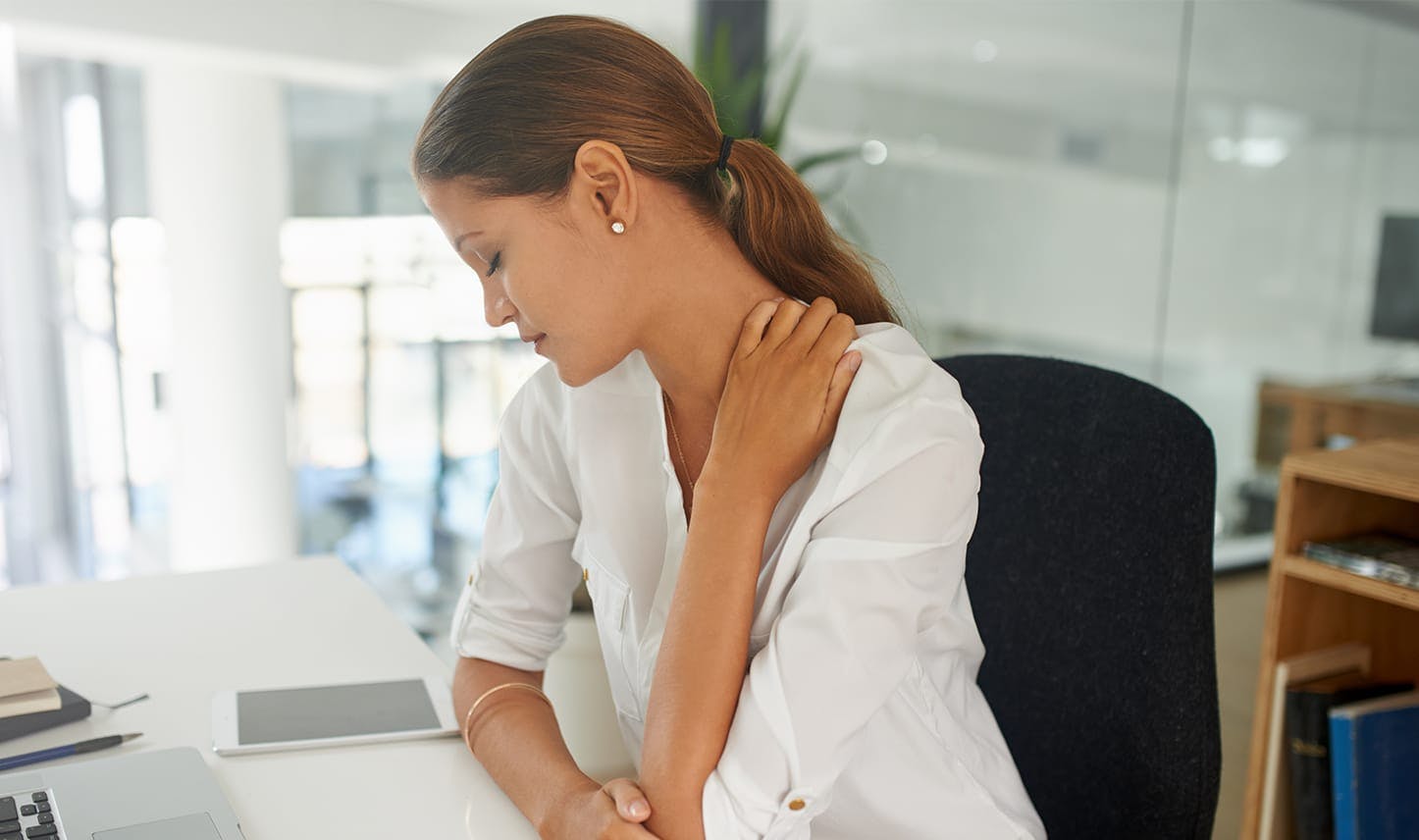 woman holding her neck in discomfort