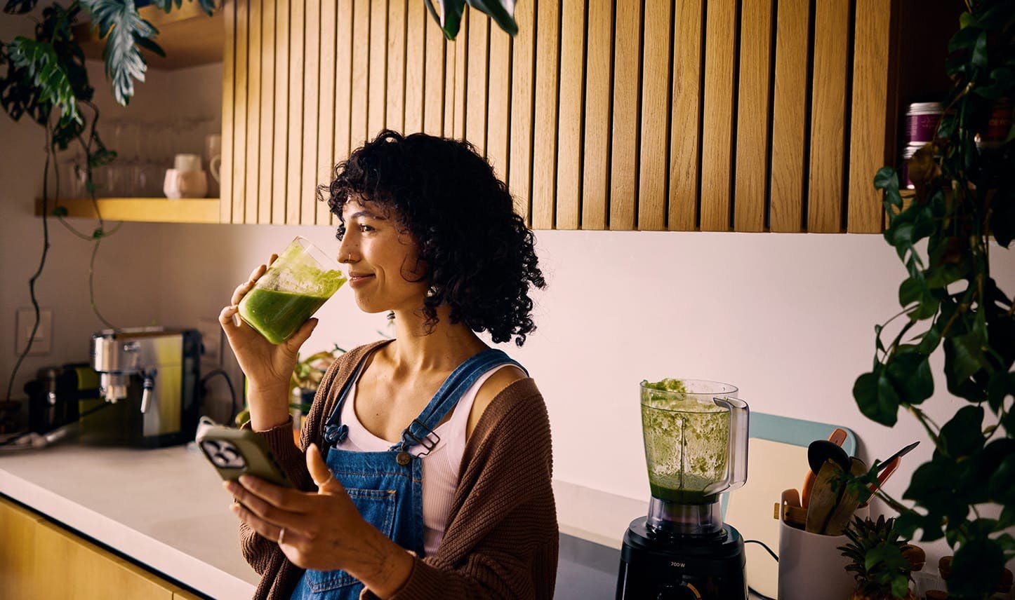 woman drinking green juice