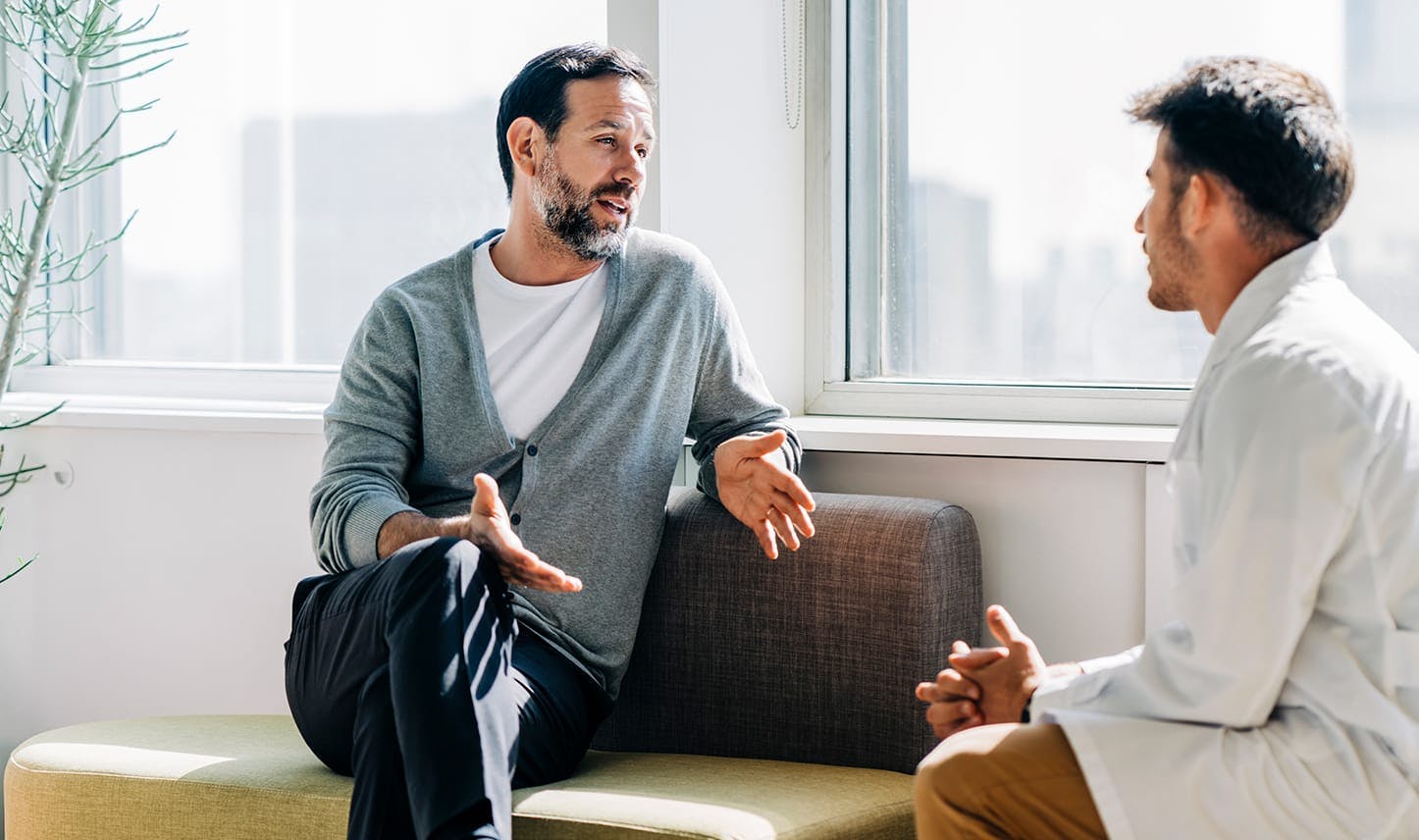 male patient speaking with medical provider