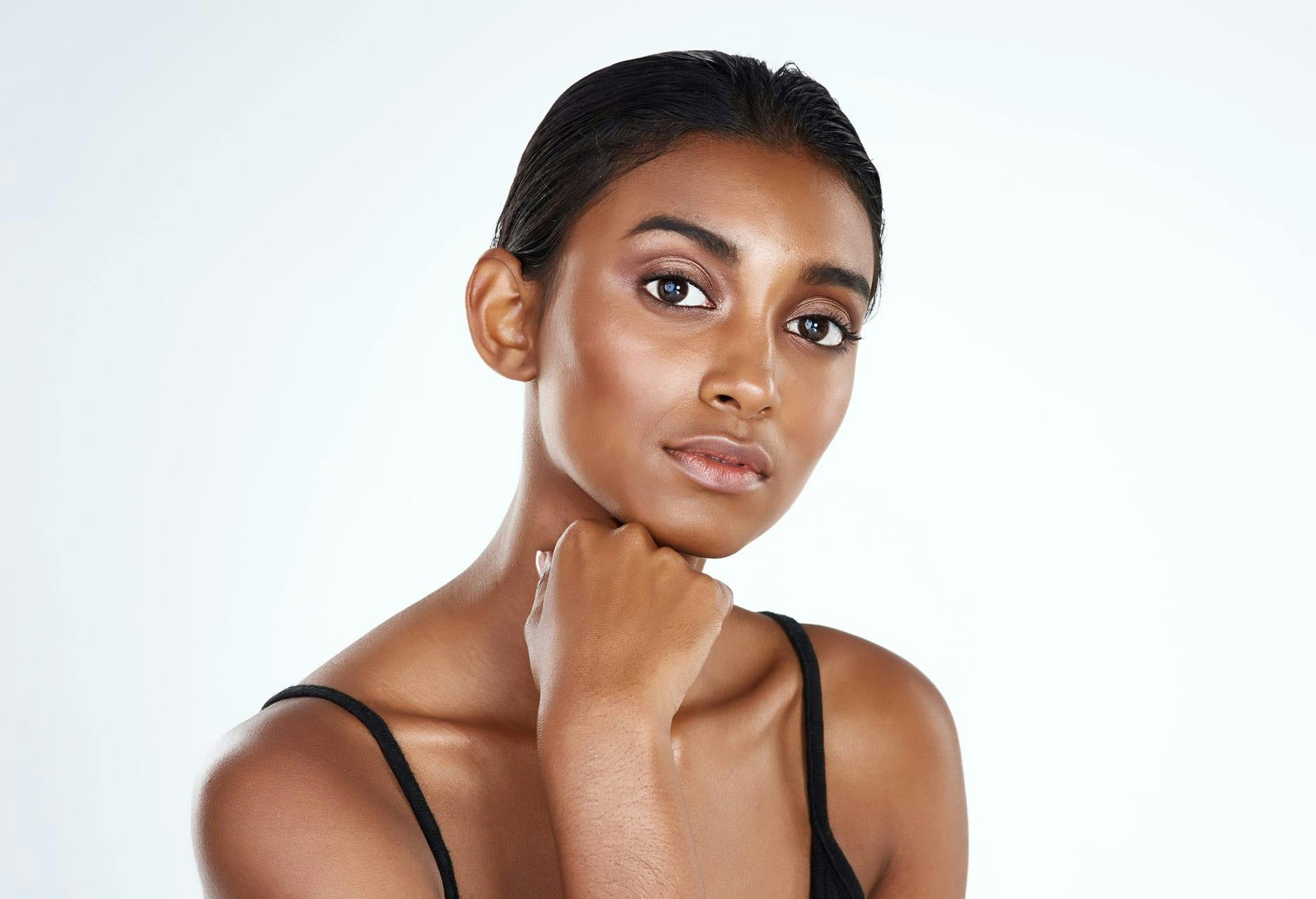 woman with fist on chin looking at camera