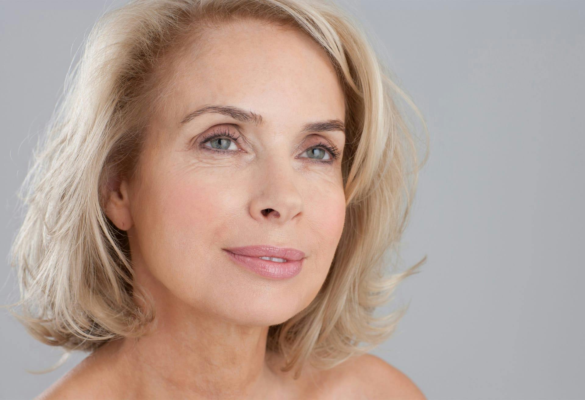 close up of woman smiling and looking off camera