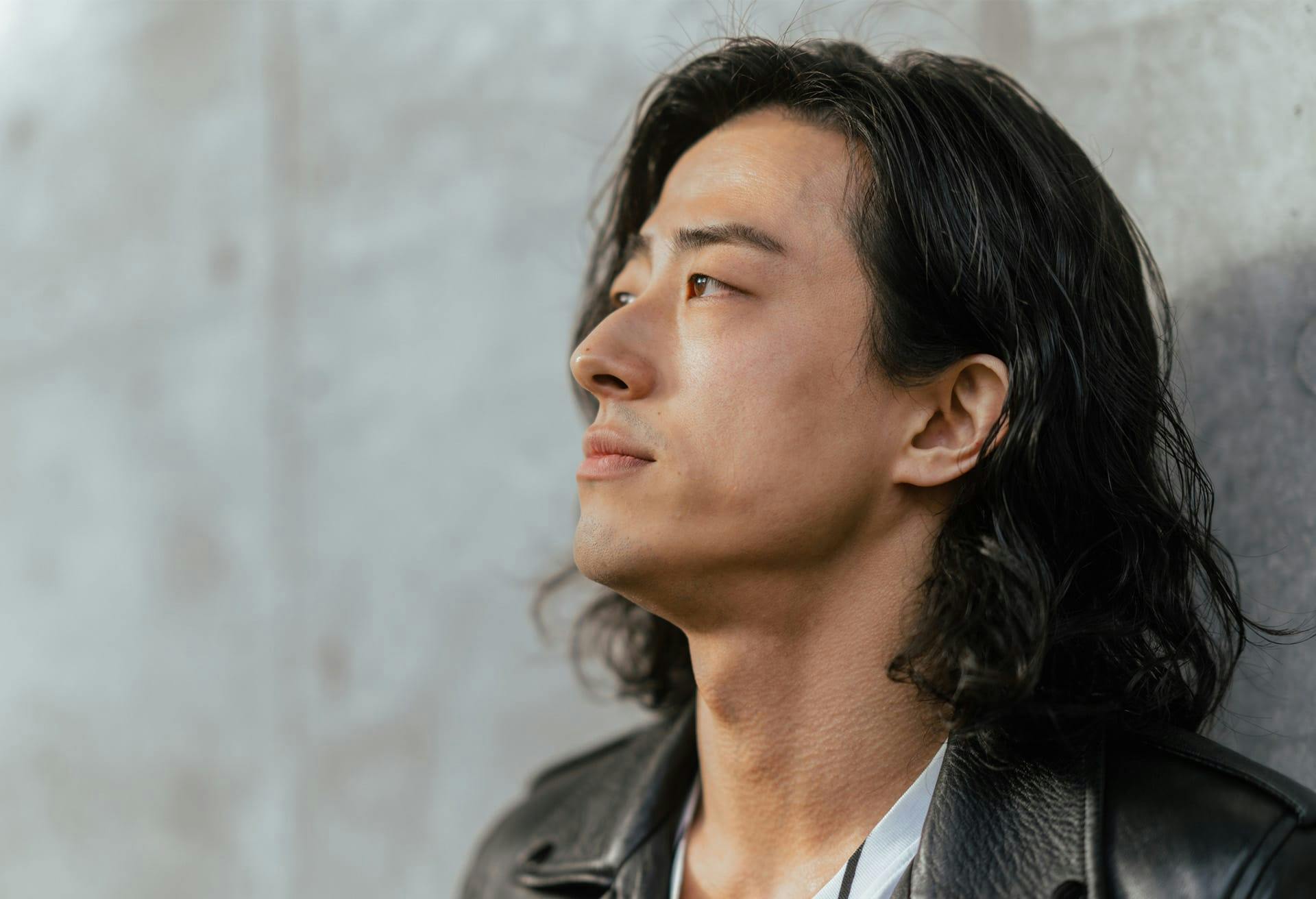 man against wall looking away from camera
