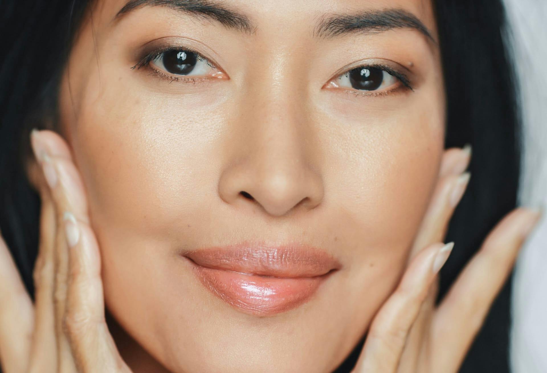 Close up of woman with hands on her cheeks