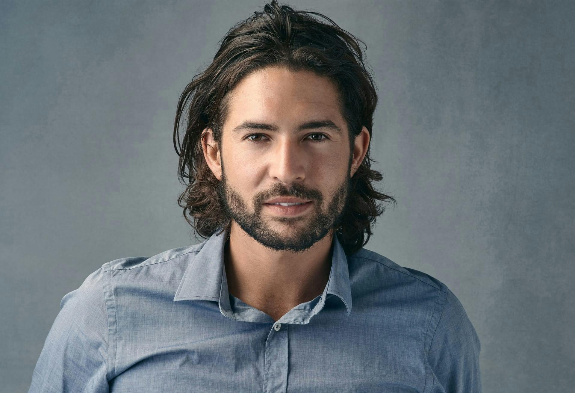 close up of man looking at camera with a smirk