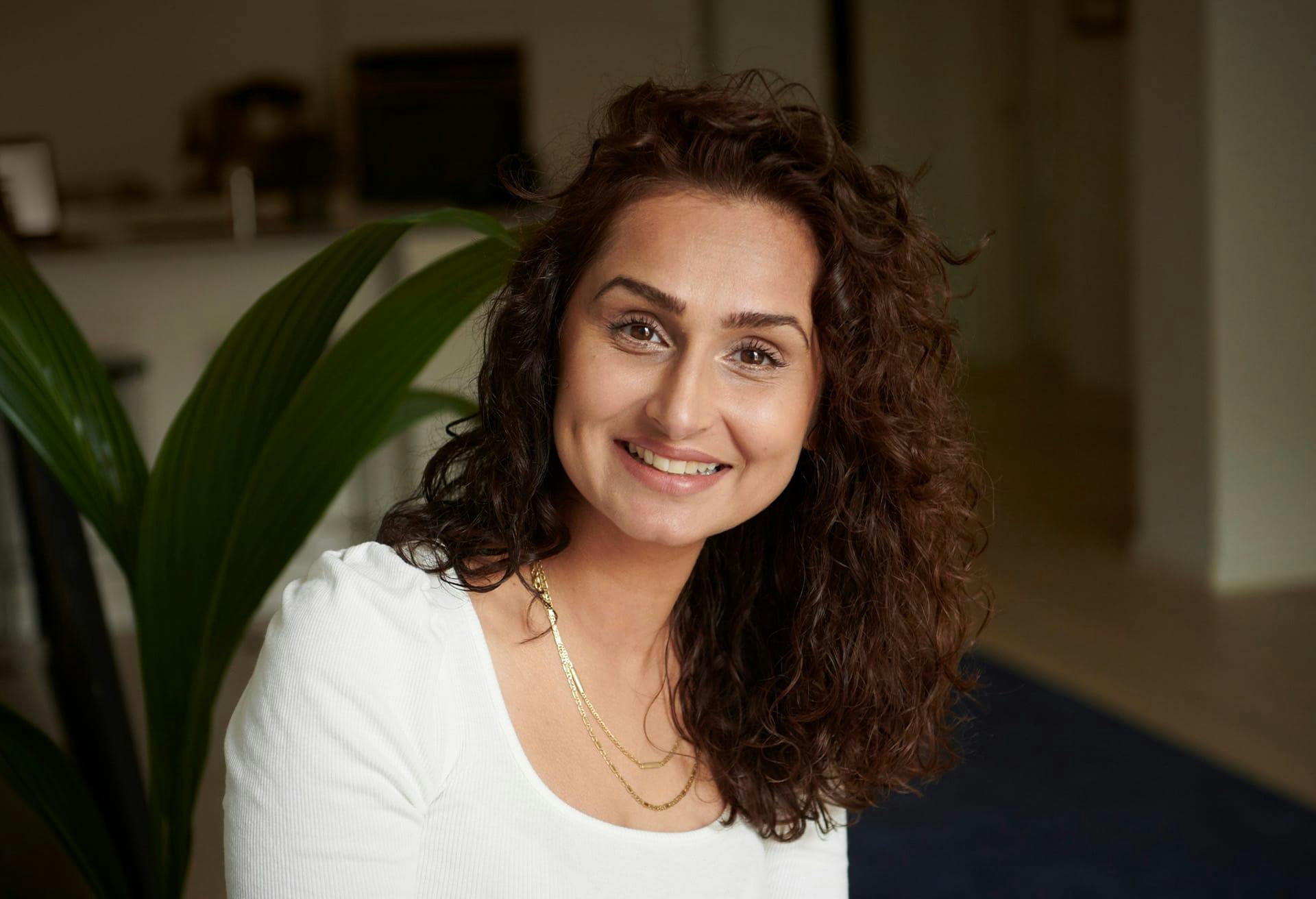 woman in a dark room smiling