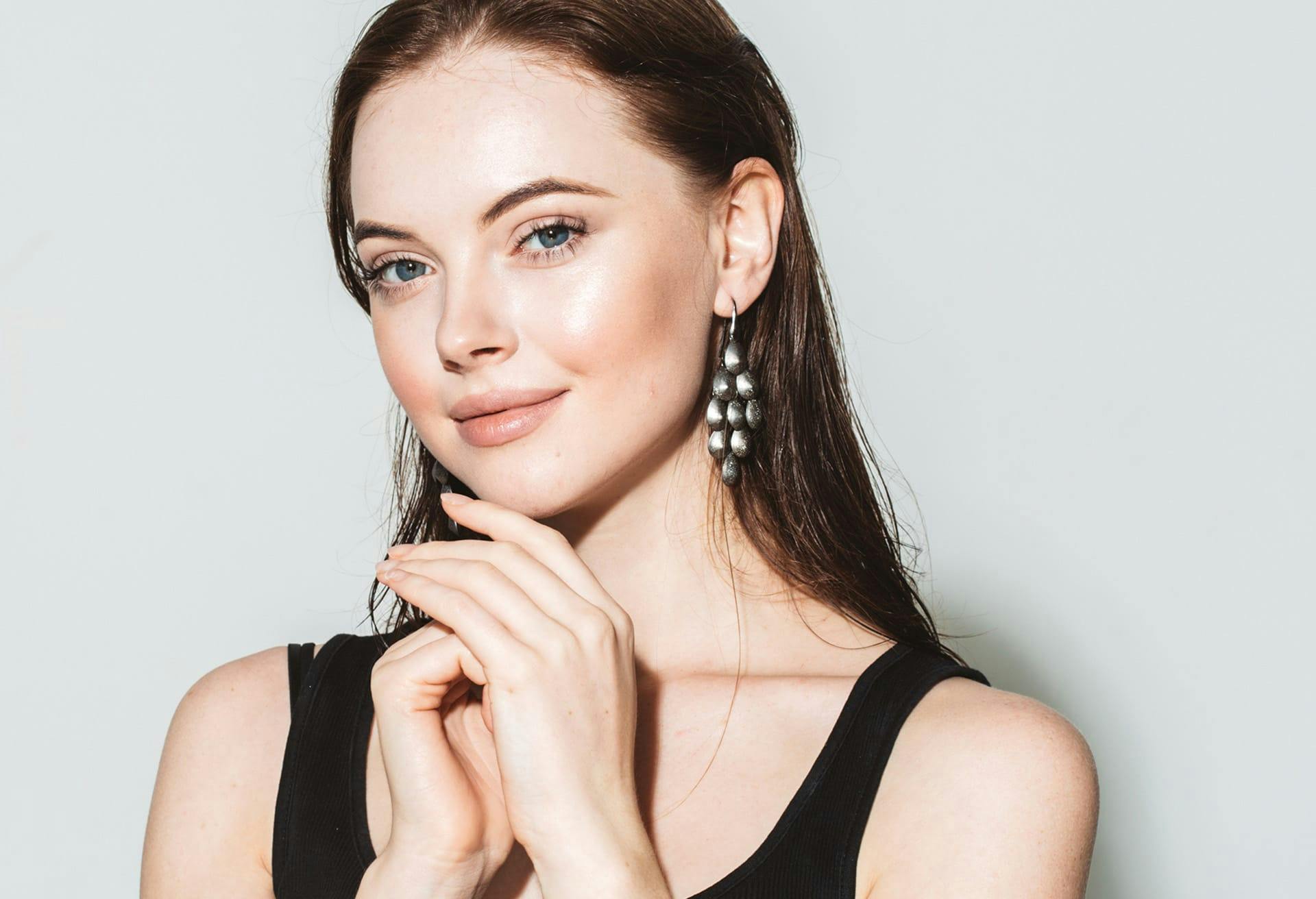woman with hand in hand smiling at camera