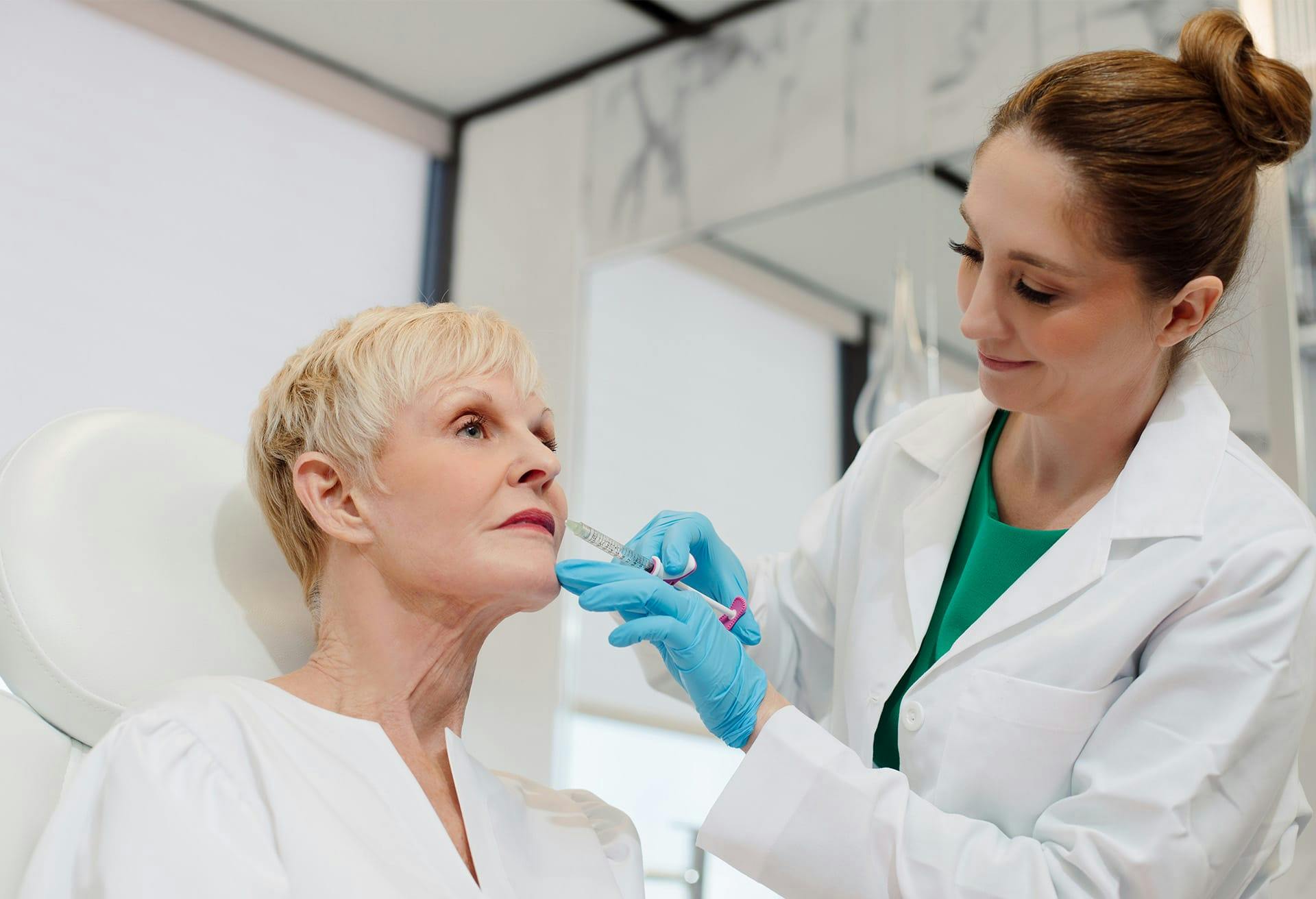 woman giving older woman an injection