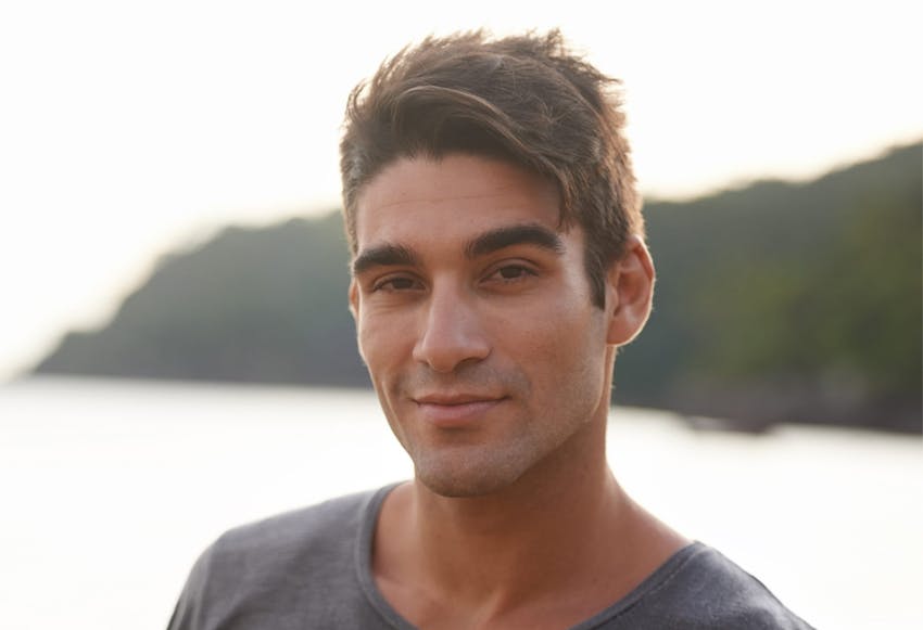 man looking at camera witha smirk