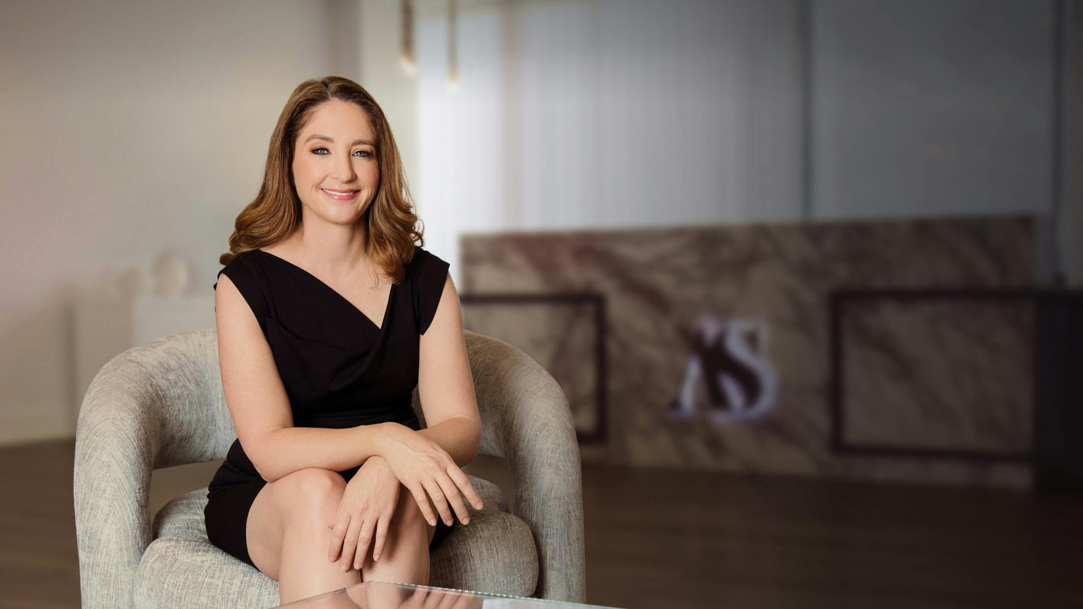 Photo of Dr. Angela Sturm sitting on a couch.