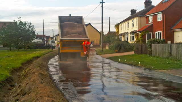 neighborhood, truck, vehicle, outdoors, shelter, ditch, water, person, housing, roof