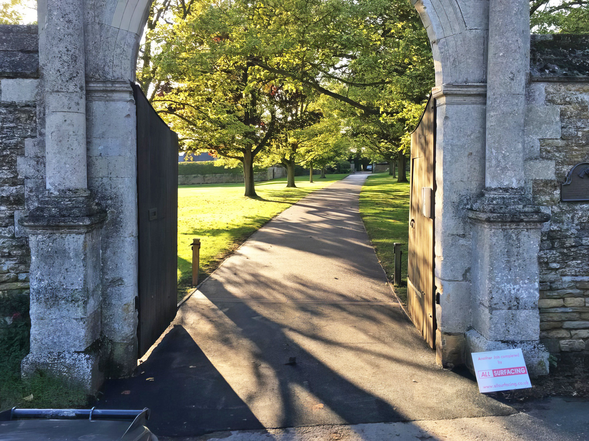 path, walkway, arch, architecture, outdoors, sidewalk, grass, plant