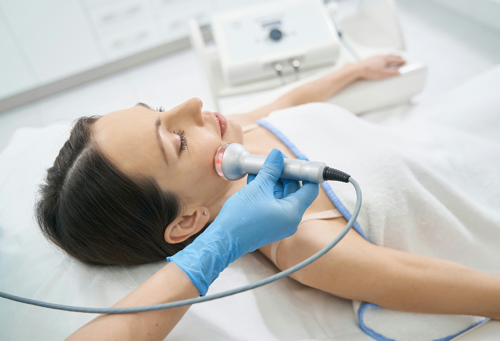 woman with eyes closed cradling face